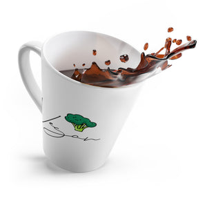 Vegan latte mug tilting over spilling coffee, with a vegan signature and broccoli