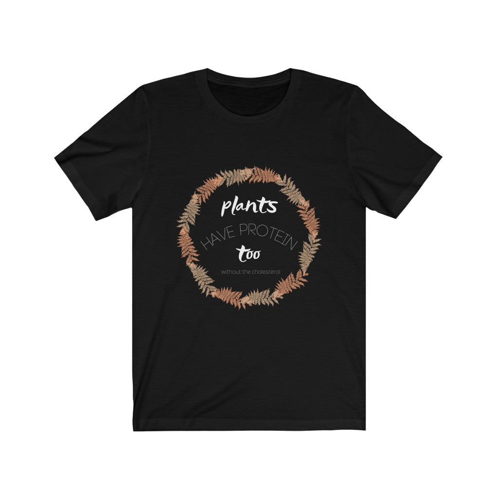 white tan and peach design on a black vegan t shirt on a plain white background, saying plants have protein too without the cholesterol, from ethical clothing brands and companies that donate to nonprofits