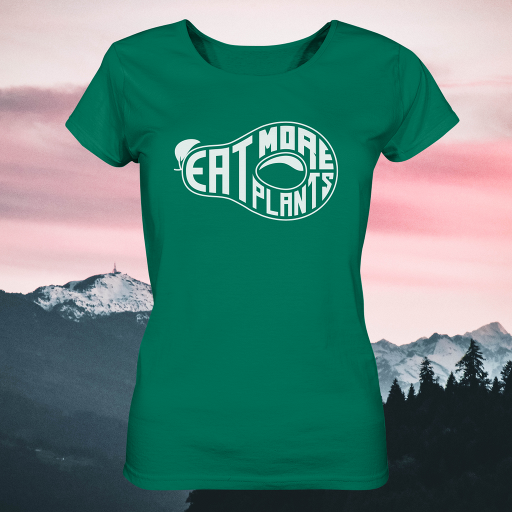 Organic ladies fitted scoop neck t-shirt in bright green saying Eat More Plants with sunset background