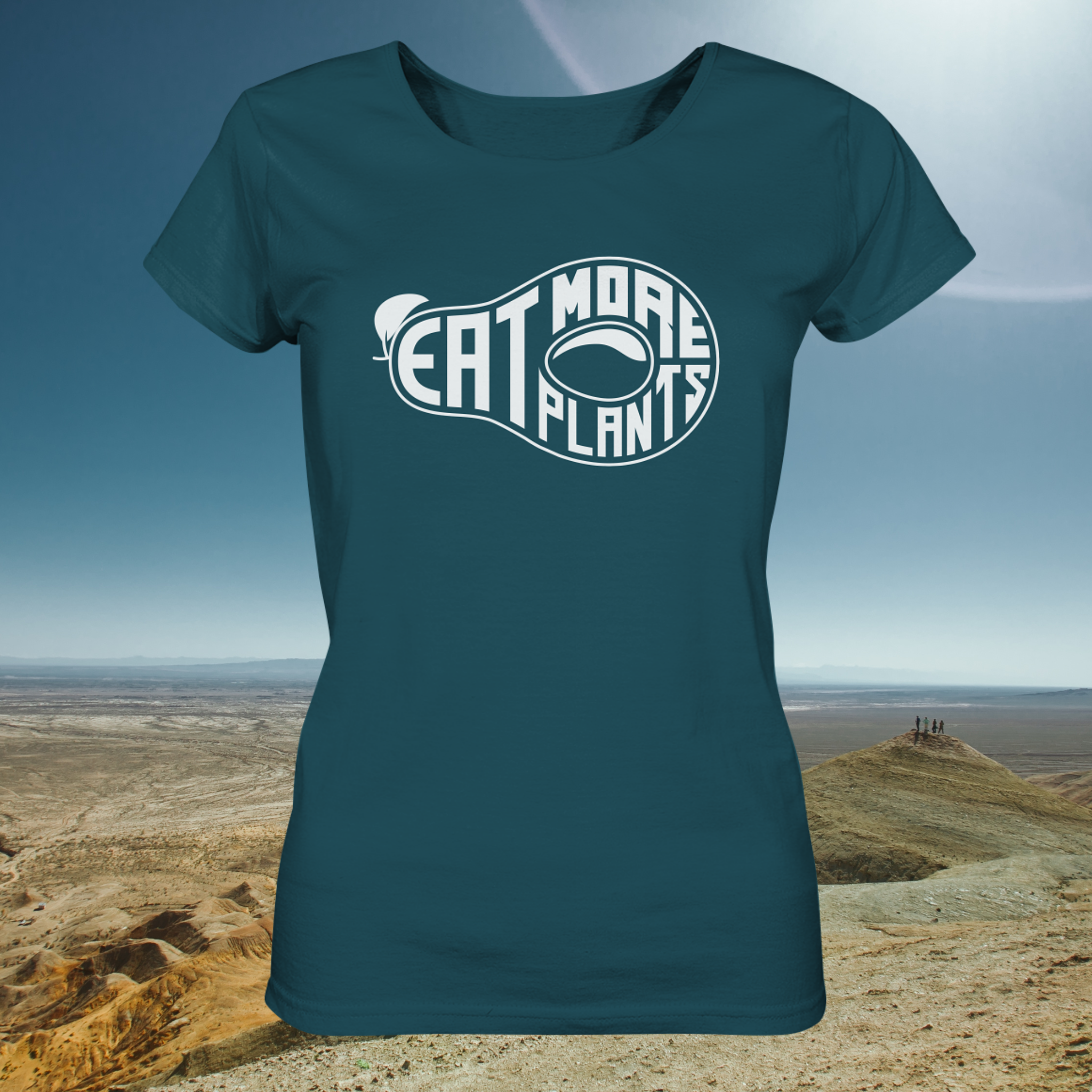 Organic ladies fitted scoop neck t-shirt in deep teal saying Eat More Plants on a sunny desert background