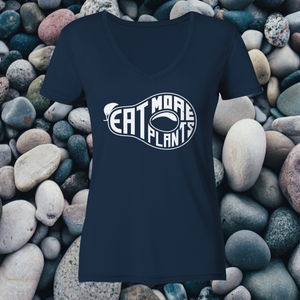 Organic ladies' v-neck vegan tshirt in french blue saying eat more plants on a background of river pebbles and rocks
