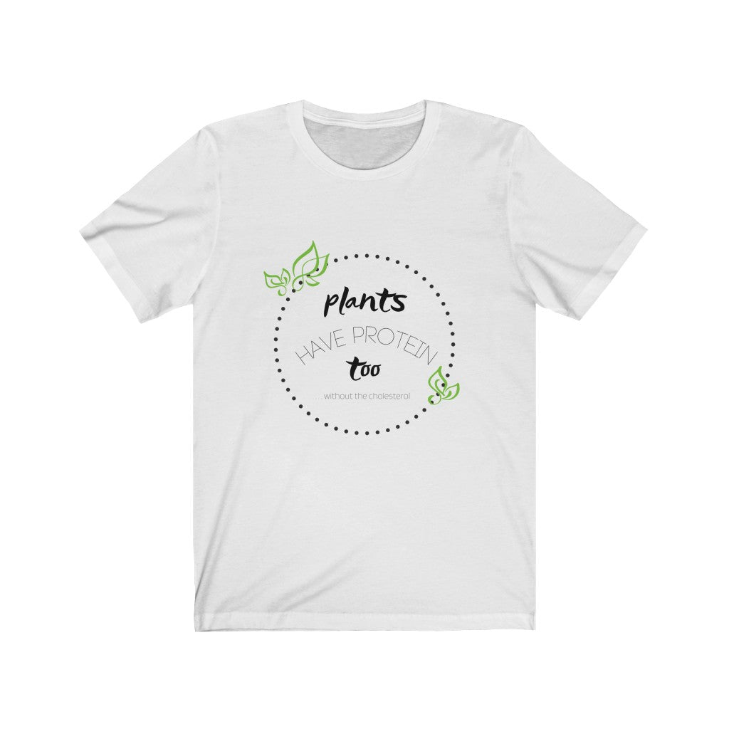 white vegan shirt with black and green design saying plants have protein too without the cholesterol laying flat on white background, from ethical clothing brands and companies that donate to nonprofits