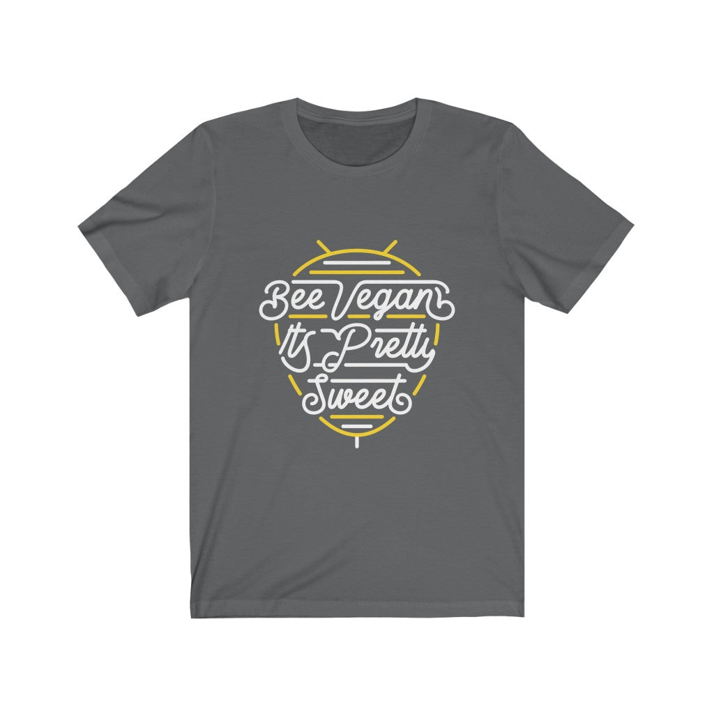 white lettering and yellow bee neon sign graphic design on asphalt (grey) premium cotton t shirt pictured flat with words bee vegan its pretty sweet, vegan t shirts from ethical clothing brands