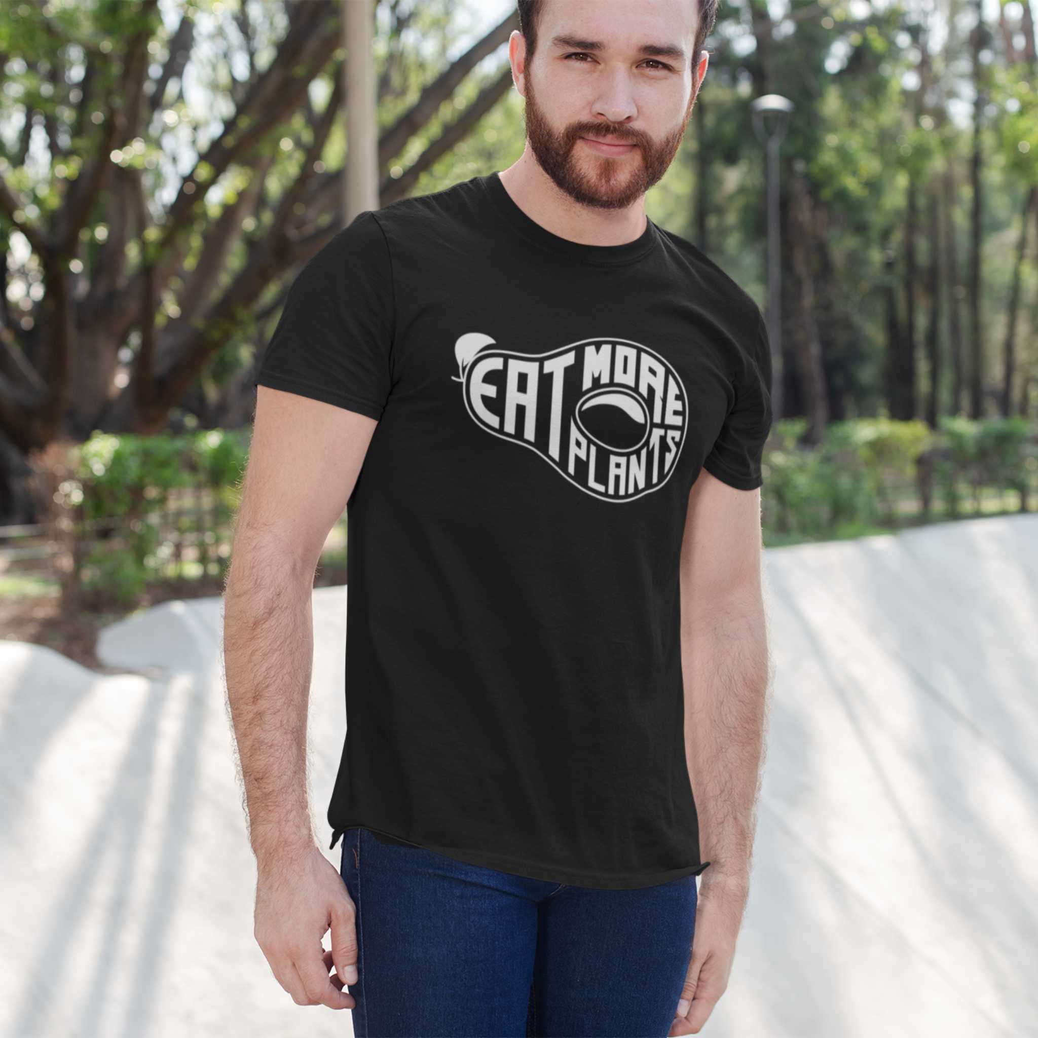 man wearing organic t-shirt, vegan tshirts saying eat more plants on black 100% organic cotton