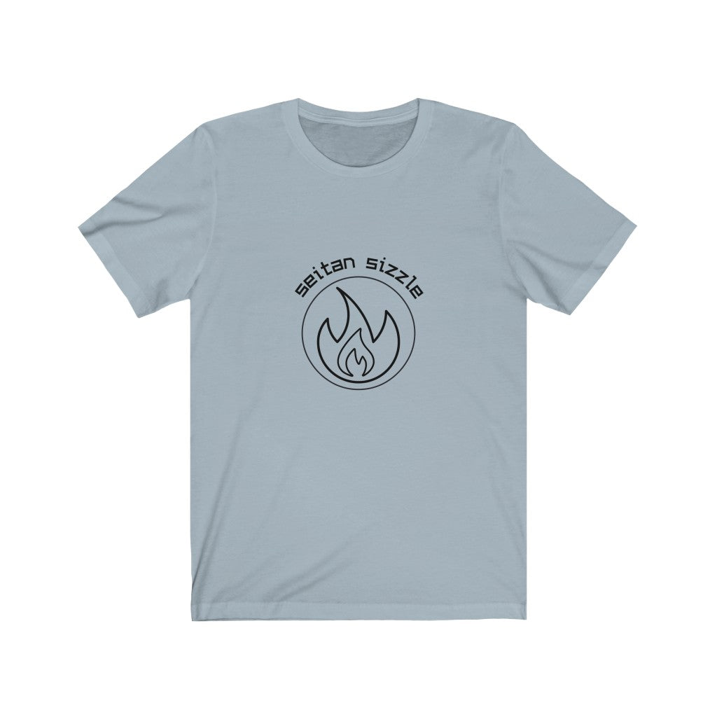 light blue colored vegan shirt with black graphic saying seitan sizzle over a circle with a flame design, laying flat on a plain white background, from vegan clothing brands