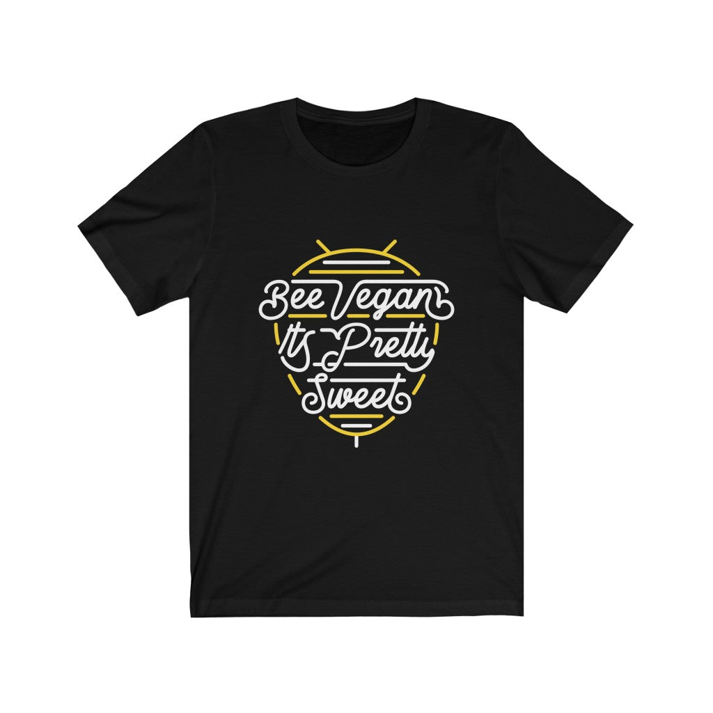 white lettering and yellow bee neon sign graphic design on black premium cotton t shirt pictured flat with words bee vegan its pretty sweet, vegan t shirts from ethical clothing brands