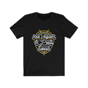 white lettering and yellow bee neon sign graphic design on black premium cotton t shirt pictured flat with words bee vegan its pretty sweet, vegan t shirts from ethical clothing brands