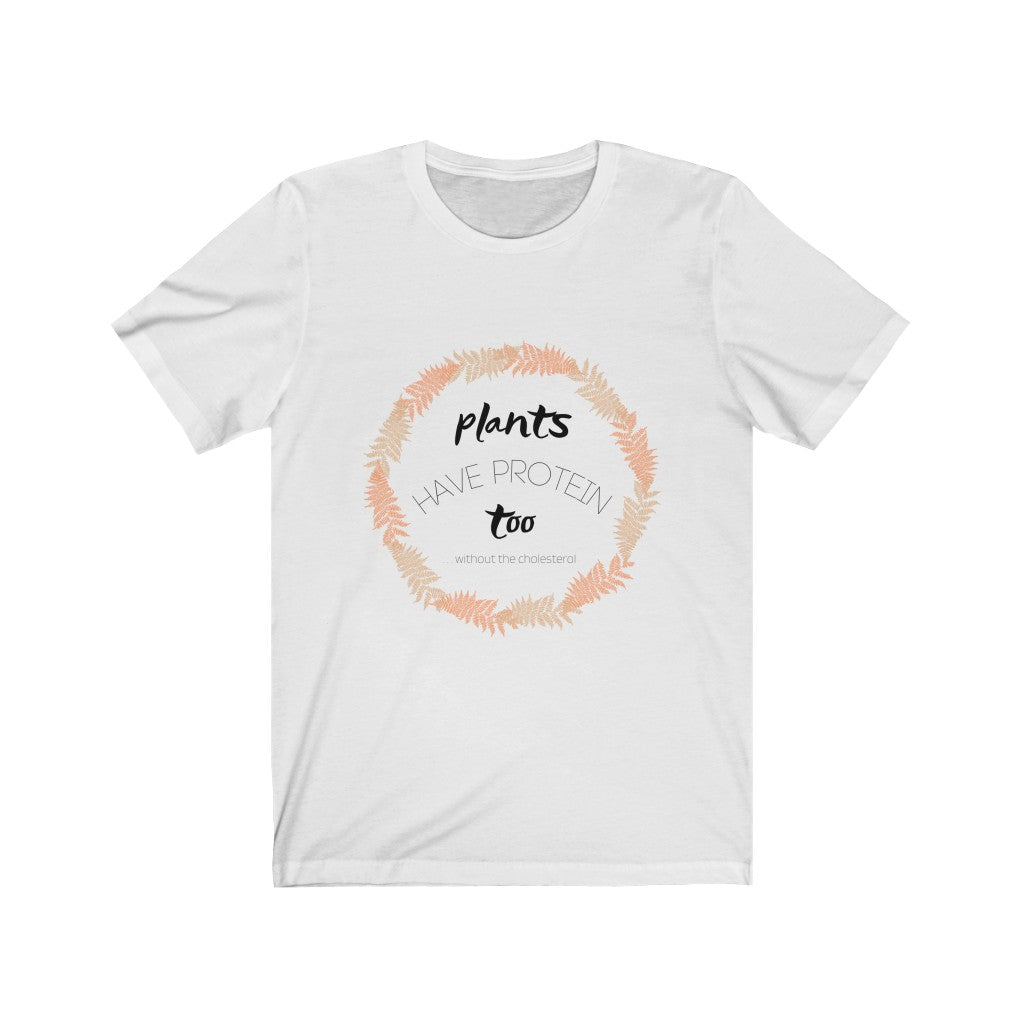 black tan and peach design on a white vegan shirt on a plain white background, saying plants have protein too without the cholesterol, from ethical clothing brands and companies that donate to nonprofits