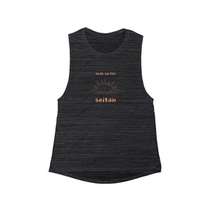 black slub color fabric with peach design of sunrise and words "soak up the seitan" for vegan tank tops
