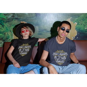 fierce style couple wearing sunglasses and eco friendly t shirts saying bee vegan its pretty sweet in neon sign graphic design, woman wearing black premium tee, man wearing navy color vegan t shirt