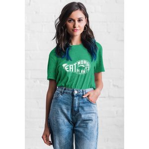 cool young woman standing wearing heather kelly green vegan t shirt saying eat more plants in the shape of an avocado, ethical clothing brands
