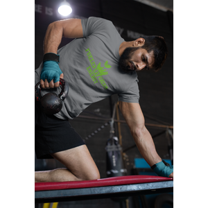 bearded muscular man doing tricep pull with a dumbbell wearing a "fueled by green energy" design on an asphalt colored vegan t shirt and vegan workout clothes