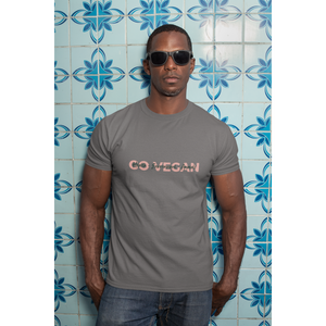 man with sunglasses leaning on blue tile wall wearing asphalt colored premium tee with go vegan health environment animals design, for vegan shirts and ethical clothing brands