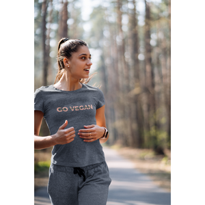 go vegan t shirt design on heather navy premium tee on woman running on a path with trees
