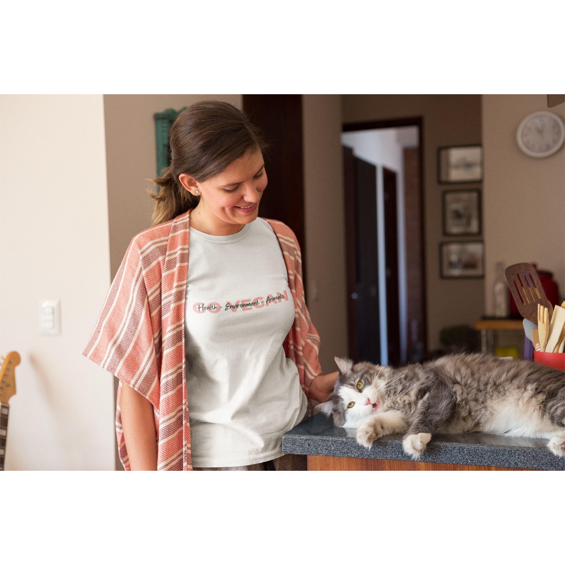 woman petting a cat wearing go vegan health environment animals design on white premium tee, for vegan shirts and ethical clothing brands