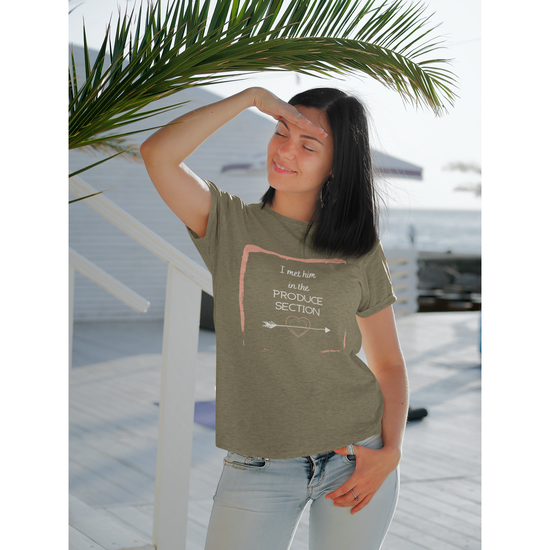 woman wearing I met him in the produce section vegan t shirt for vegan couples on a heather olive premium tee with design featuring white words and arrow through heart with a pink frame