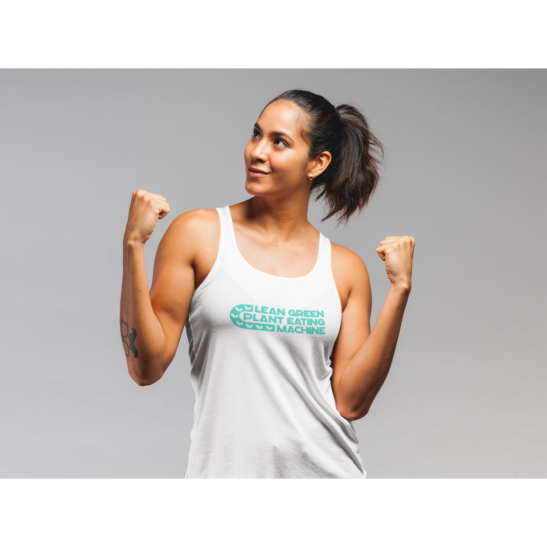 Lean green plant eating machine design in teal on a white premium vegan tank top worn by a woman flexing her biceps