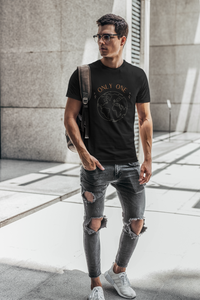 Man with a backpack and ripped jeans wearing a vegan organic t-shirt saying only one earth