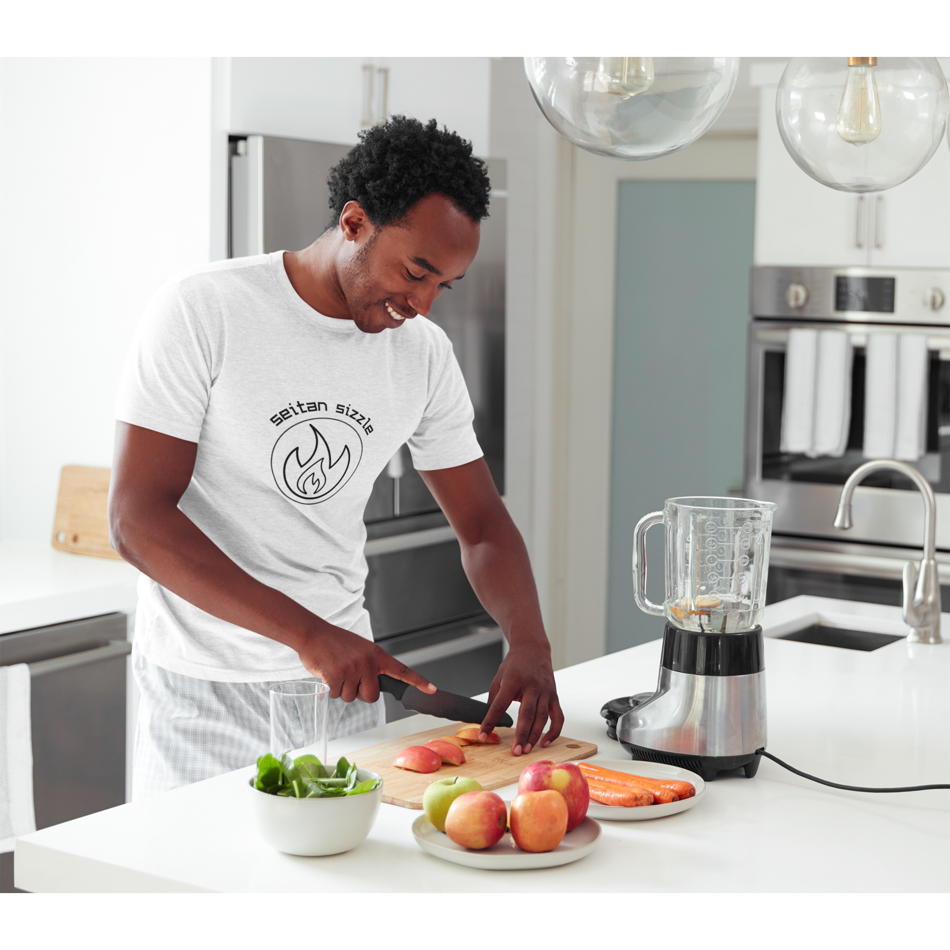 man cooking seitan recipes wearing white colored vegan shirt with black graphic saying seitan sizzle over a circle with a flame design, from ethical clothing brands