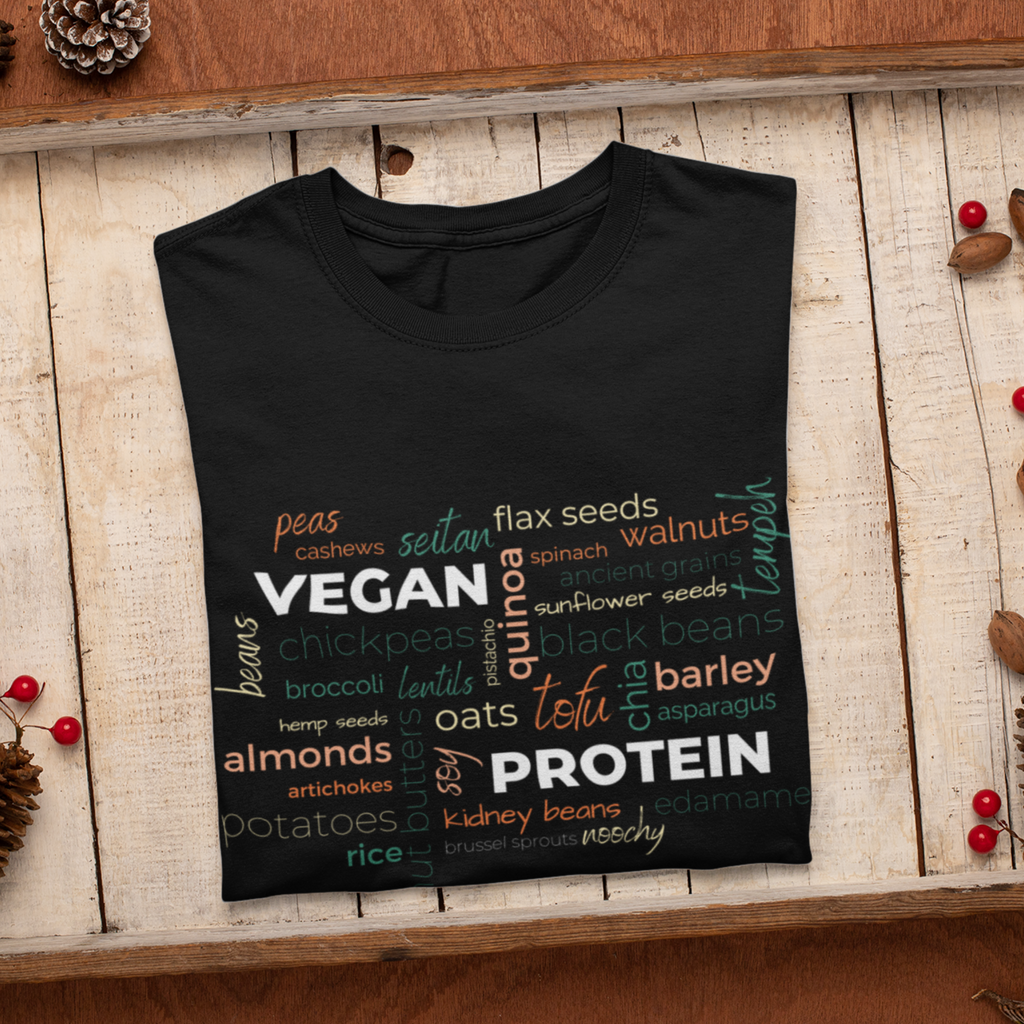 vegan protein word salad in fall colors on a black premium vegan t shirt folded
