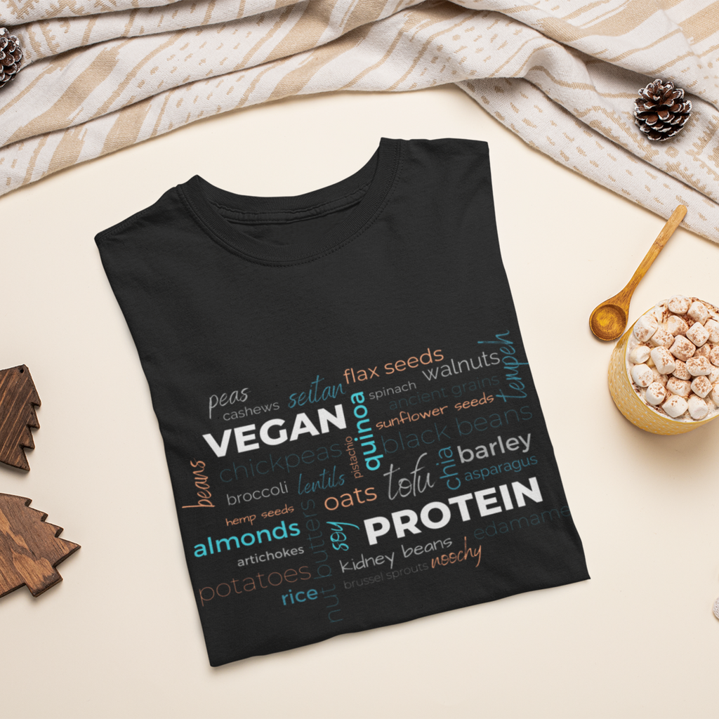 vegan t shirt in black with a vegan protein word salad in winter colors on a flat surface with winter decorations