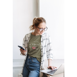 woman working on her computer  wearing a vegan t shirt saying vegan to reverse heart disease