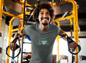 vegan heartbeat t-shirt with a dumbbell, on dark grey, worn by a man at the gym
