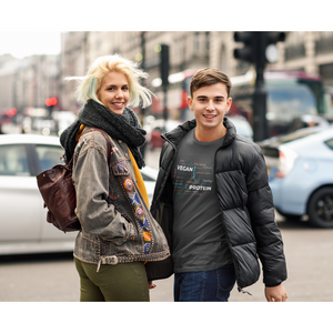 man standing next to his girlfriend in a city with man wearing a dark grey vegan tshirt with vegan protein word salad in winter colors 